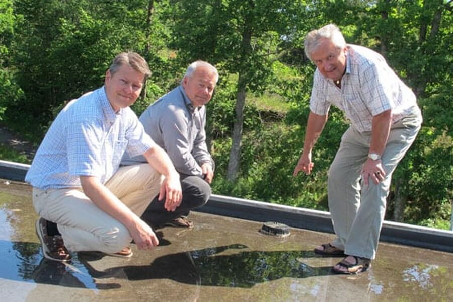 Solen skinner en varm sommerdag, men taket er fullt av vann. Aiwell-teamet peker på årsaken, det tette sluket. Fra v.: Tore Johnsen, Rune Larsen og Asle Johnsen.