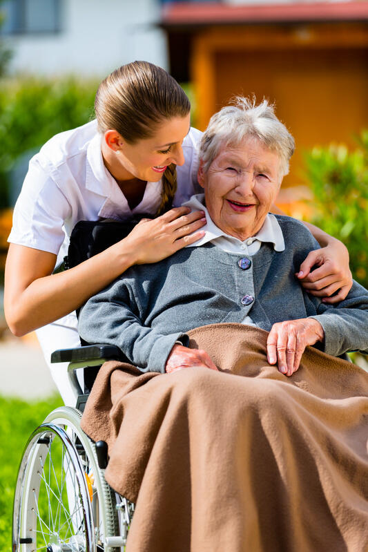 mp16285266-senior-woman-in-nursing-home-with-nurse-in-garden