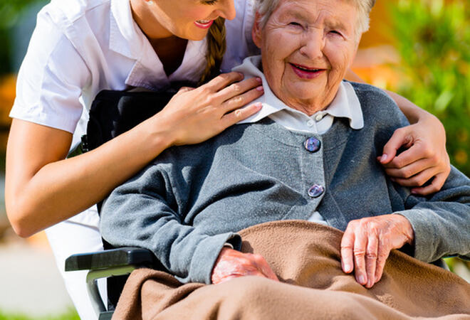 mp16285266-senior-woman-in-nursing-home-with-nurse-in-garden