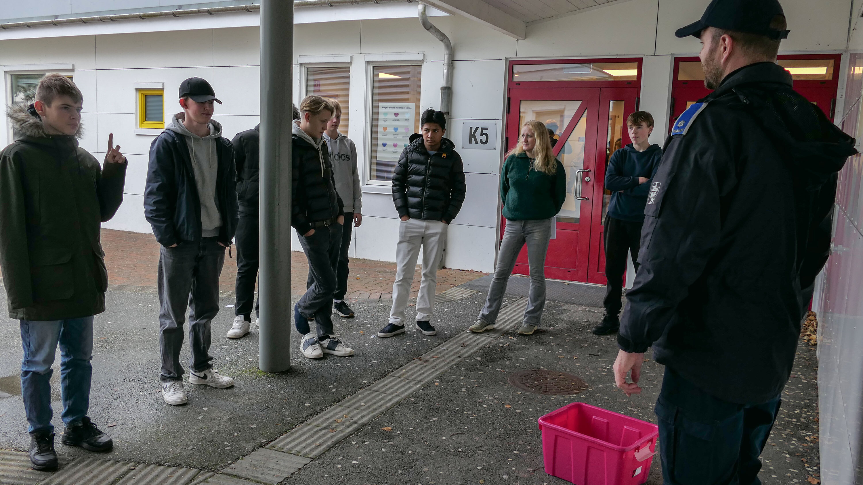 Ungdommer som får høre hva de skal gjøre på vannkokingsposten