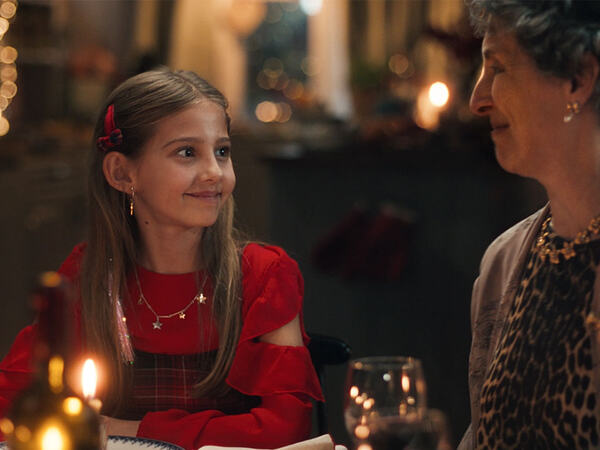 Et barn og en bestemor som feirer jol og spiser middag sammen